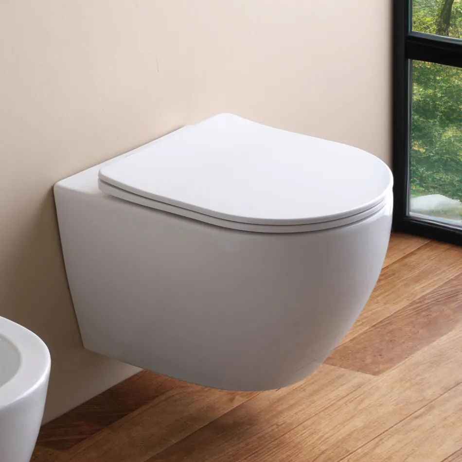 Podwieszana toaleta bezrantowa z wolnoopadającą ceramiczną deską sedesową – Juniper   Viadurini